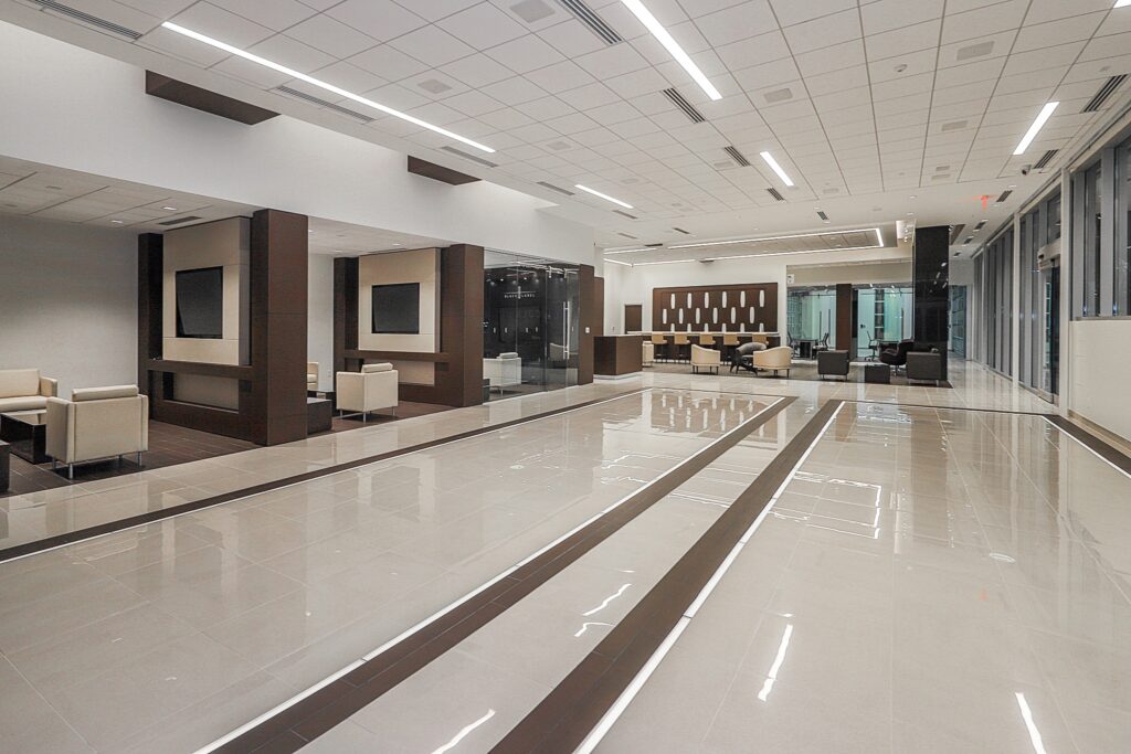Entry way and office bays in a large open dealership with white floors