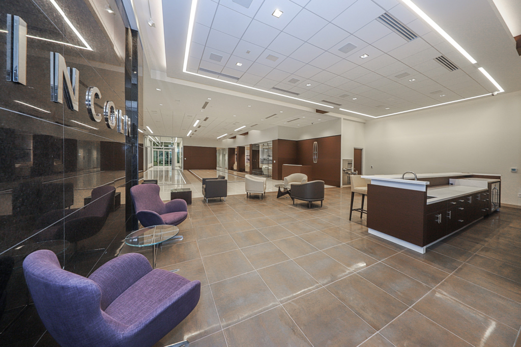 Interior of lincoln dealership lobby with purple couch