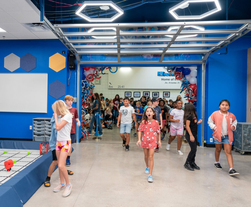 children eagerly entering Hull media center through garage door entrance