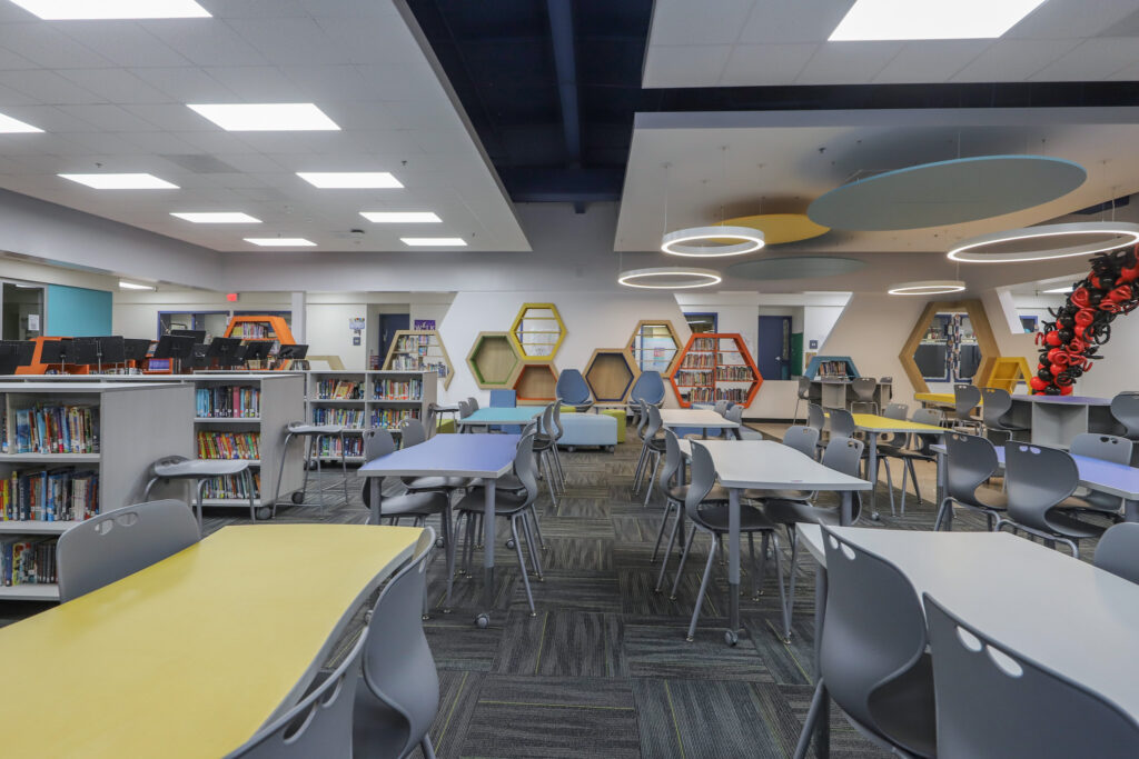 Frye Elementary School media center with desks, bookshelves, and cubby benches in the wall