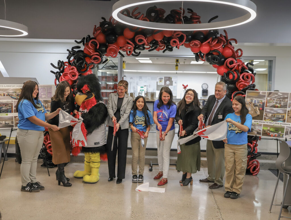 Frye Elementary School and Concord General Contracting representatives cutting ribbon under balloon arch