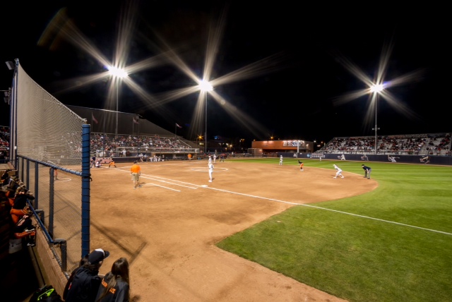 outdoor softball stadium night time first base line