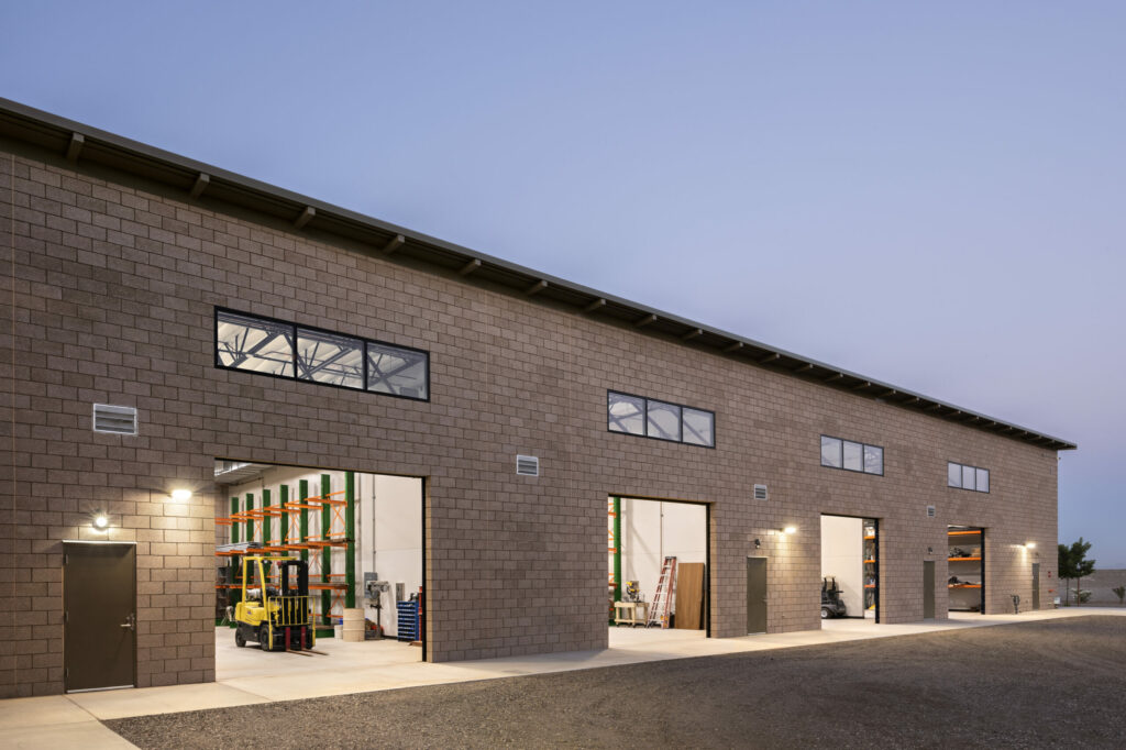 Exterior shot of the building with a few roll up doors opened