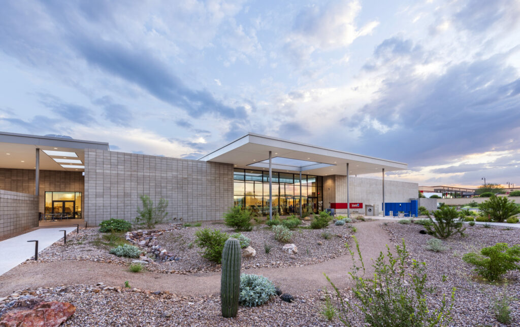 exterior of modern library with an awning and desert landscape